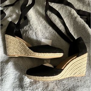 Black espadrilles. H2O & stain resistant. Canvas top & ribbons. Man made sole.